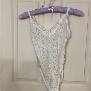 White see-through lace lingerie bodysuit.